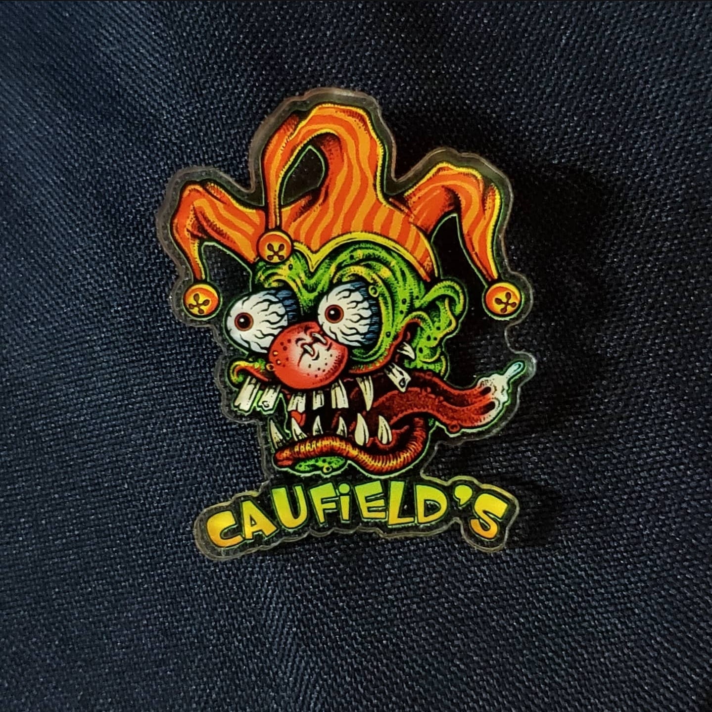 Caufield's Acrylic Jester Head Logo Pin